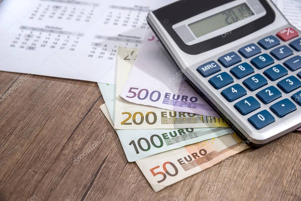 calendar, euros and calculator, coin placed on a table