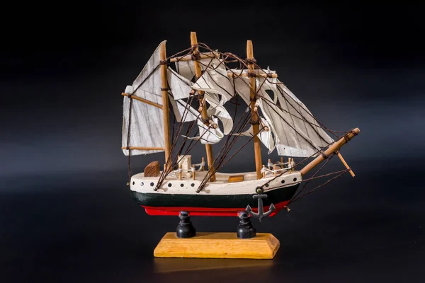 Wooden ship toy model, isolated on black background