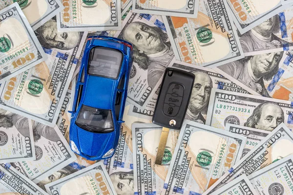 blue toy car with car key on dollar.