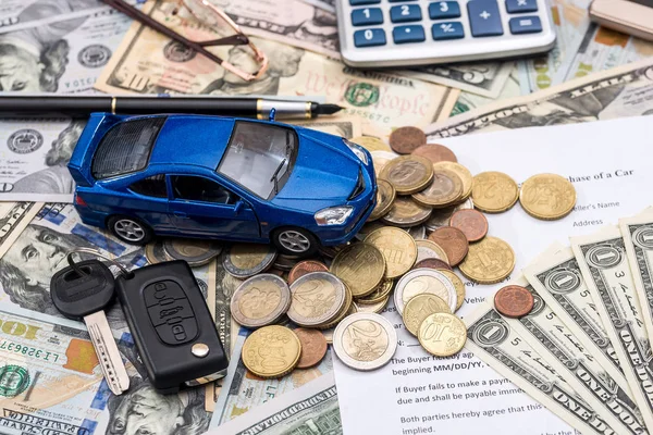 car contract, toy car, dollar, calculator, pen, pencil