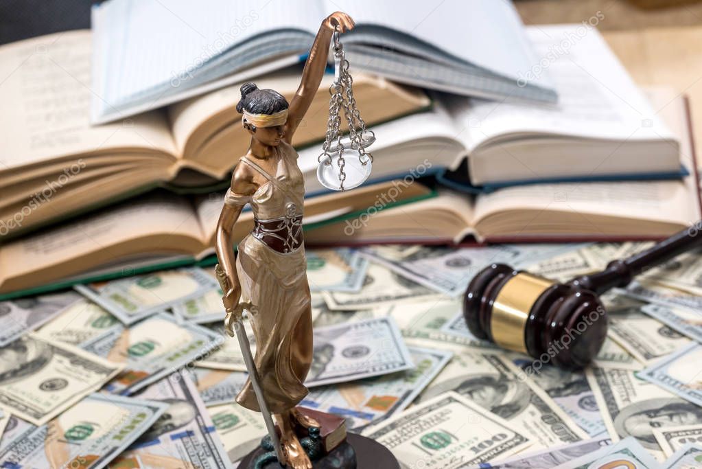 Lady justice or  themis, book and gavel on dollar bills