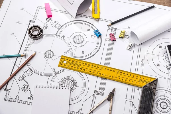 measuring tools on the background of technical drawings. view on top