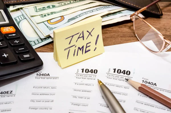 Tax time concept with 1040 tax document and money