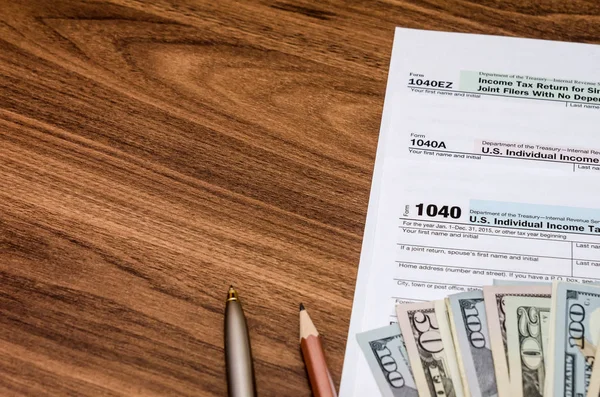 Unite States 1040 tax form with money on desk