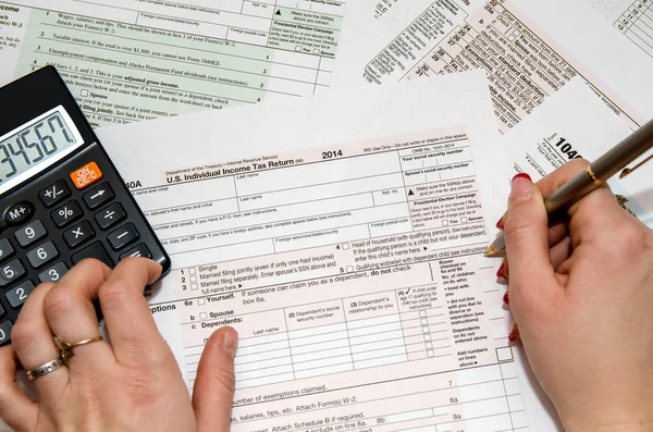 Female Filling Out 1040 Tax Form Stock Image