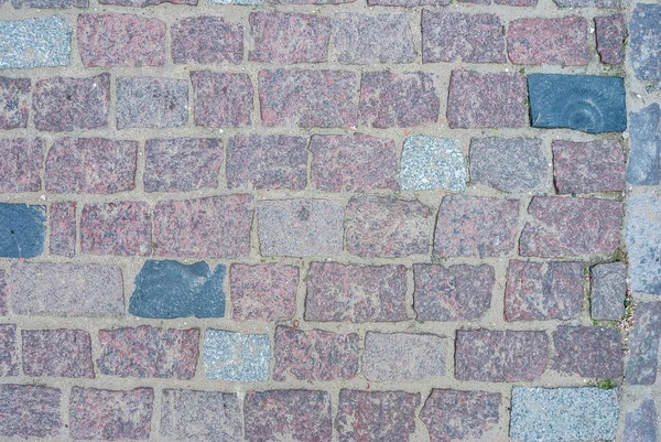 old square stone floor as texture. close up