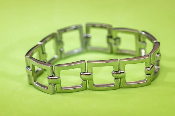 Stainless or silver bracelet for women  isolated on green background
