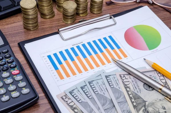 graph with tablet pc and money