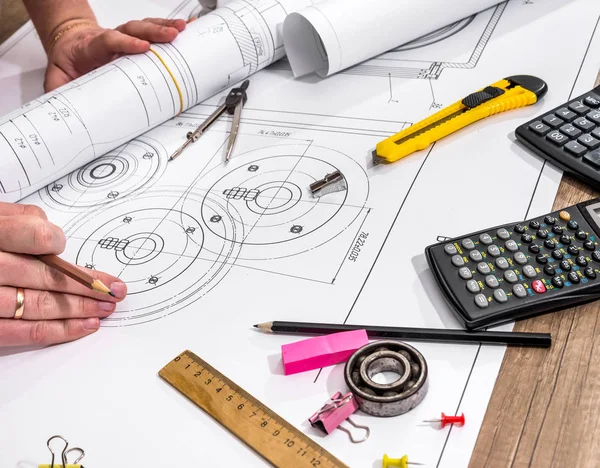 engineer measures the dimensions of the drawing.