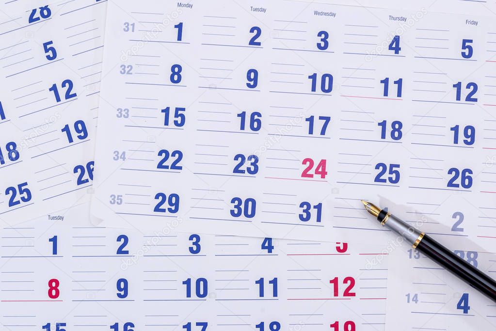 sheets of calendar and pen