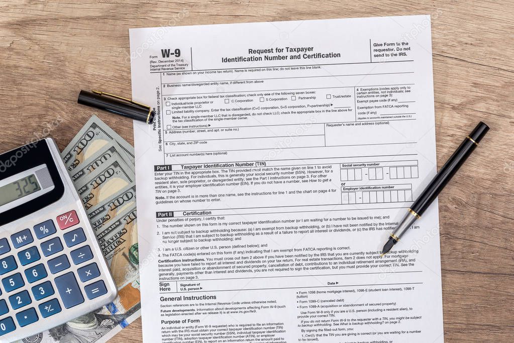 tax form - w9 - with dollar and pen.