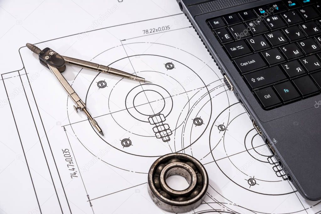 mechanical engineering of parts with tools, laptop, drawing top