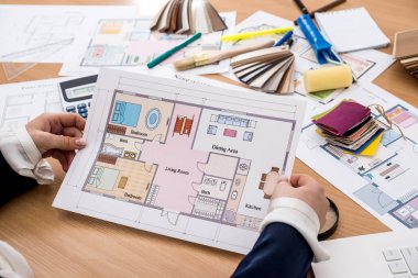 nterior designerwith color swatch and building plans on office clipart