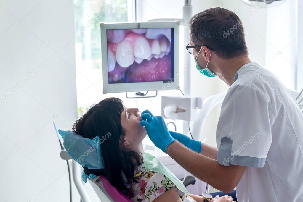 The dentist examines the patient with camera