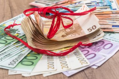 arka plan olarak kırmızı kurdele ile birçok euro banknot