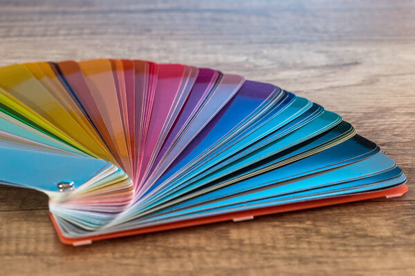 Colour striped sampler for painting on wooden desk 