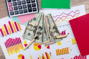American money on business graph background, close up