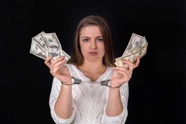Dollar bribe divided in woman hands in handcuffs
