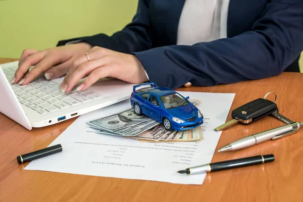 Male's hands signing on car contract claim form and calculator, dollar, car