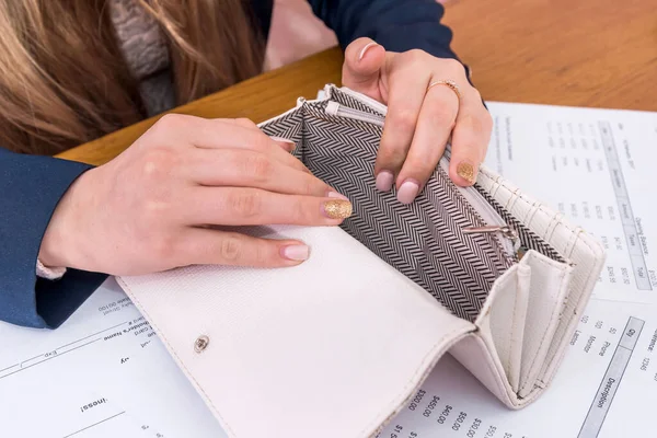 Female hands with empty purse and purchasing orders