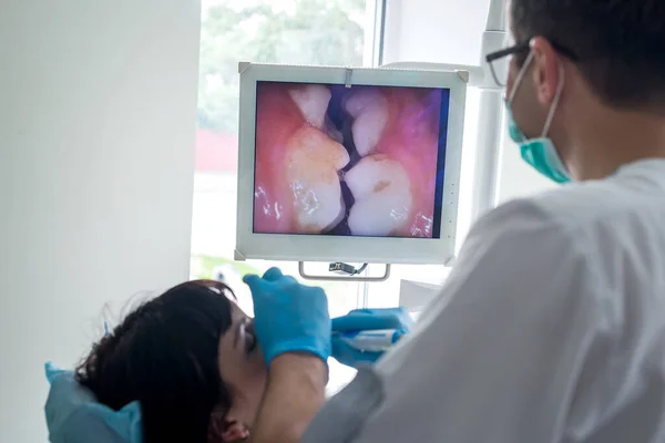 Doctor in gloves examining patient\'s teeth in dentistry