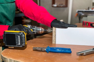 Mobilya yapan matkap makineli kadın marangoz.