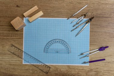 Millimeter paper with draw tools and wooden blocks