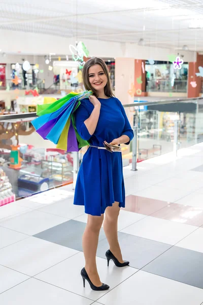 Full length of woman with pack bags on shoulder