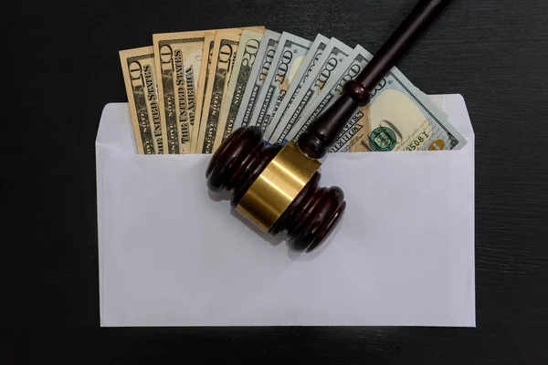 American dollars in envelope with judge's gavel on dark — Stock Photo, Image