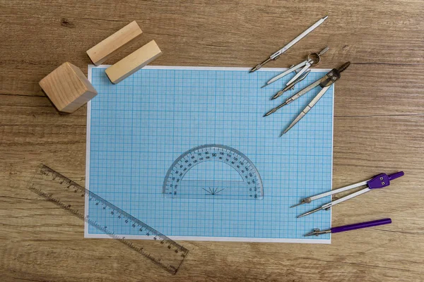 Millimeter paper with draw tools and wooden blocks