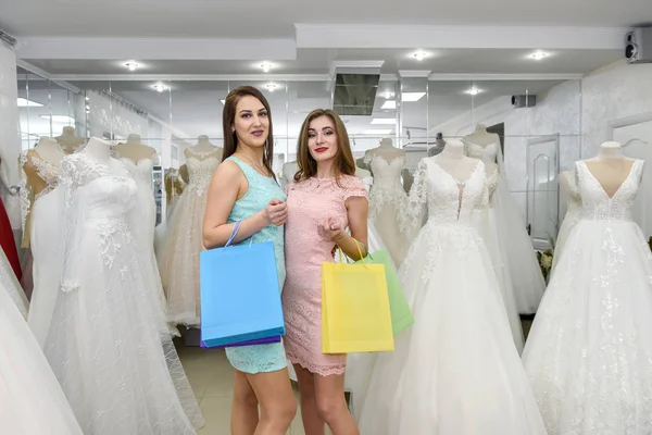 Attractive friends with shopping bags in wedding salon — 스톡 사진