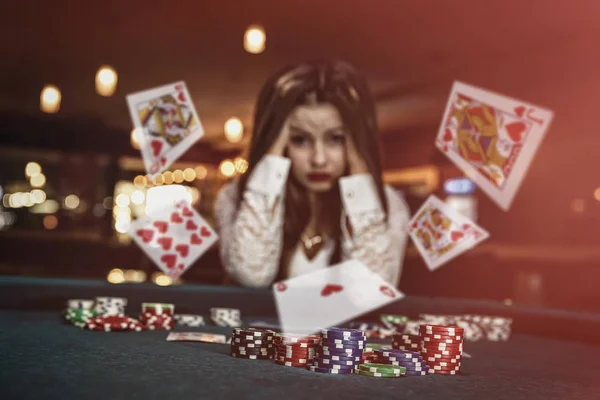 Upprörd kvinna i casino med fallande kort — Stockfoto