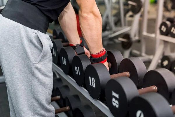 Male hands with dumbbells in gym close up — Stock Photo, Image