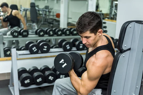 Man in gym holding dumbbell close up — Stock Photo, Image