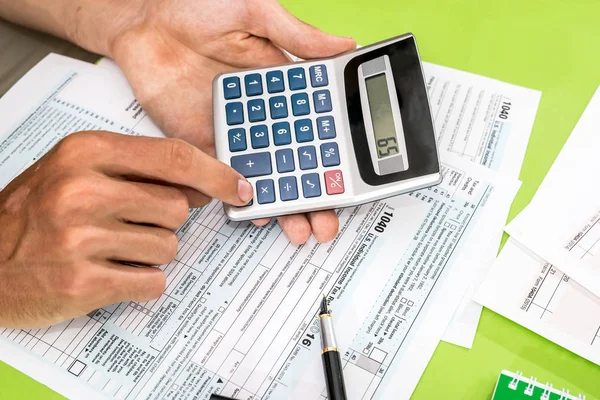 Człowiek Wypełniając Formularz Podatkowy Pióra Kalkulator — Zdjęcie stockowe