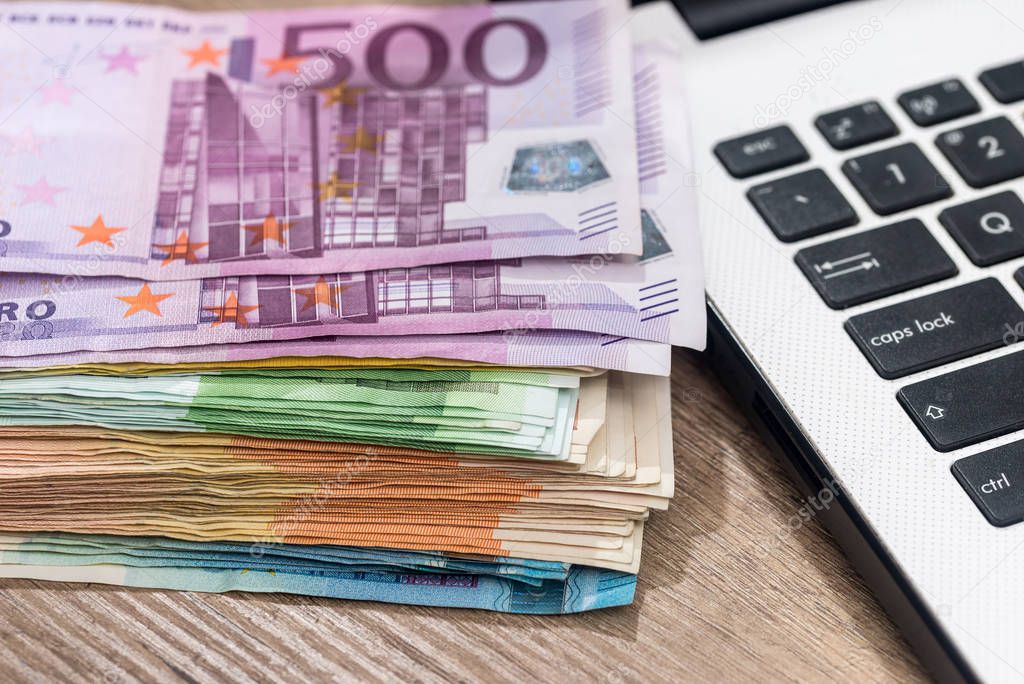 euro money on laptop. close up