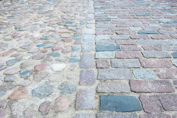 old square stone floor as texture. close up