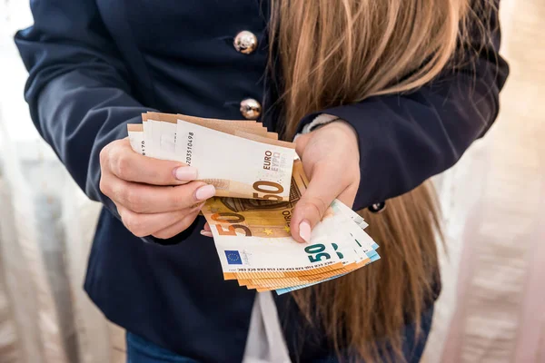 Woman hands counting euro banknotes close up