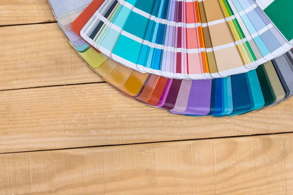 Colour swatches in fan on wooden background