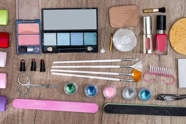 Different  cosmetic set  - makeup tools on a wooden background.
