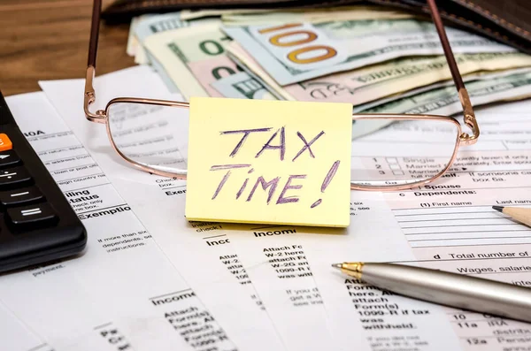 Tax time concept with 1040 tax document and money