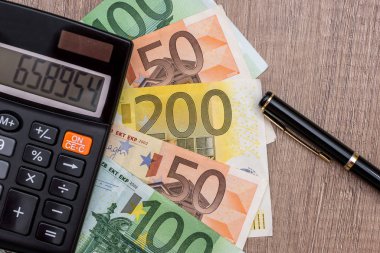 Euro, hesap makinesi ve kalem masa üzerinde