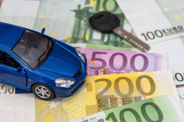 blue toy car and euro money coin and banknotes.