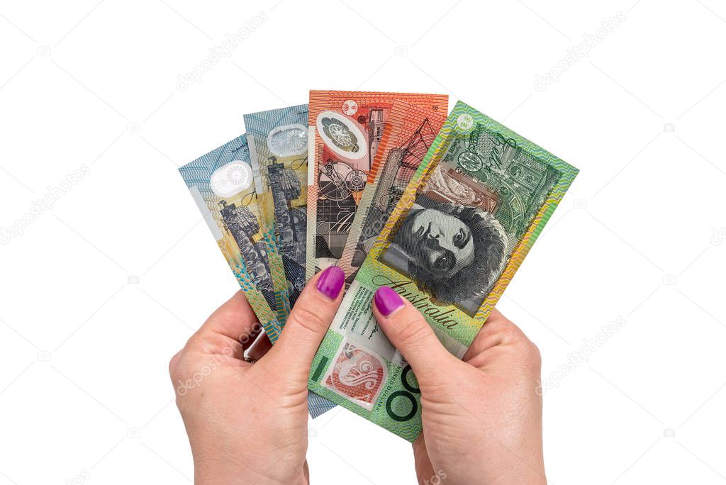 female hand hold australian dollar isolated on white