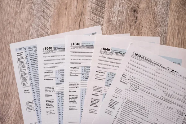 Blanks of individual tax form on wooden table