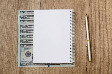 Amerikan yüz dolar ve kalem ve masa üzerinde boş Not