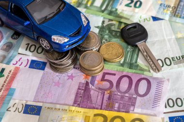 blue toy car and euro money coin and banknotes.