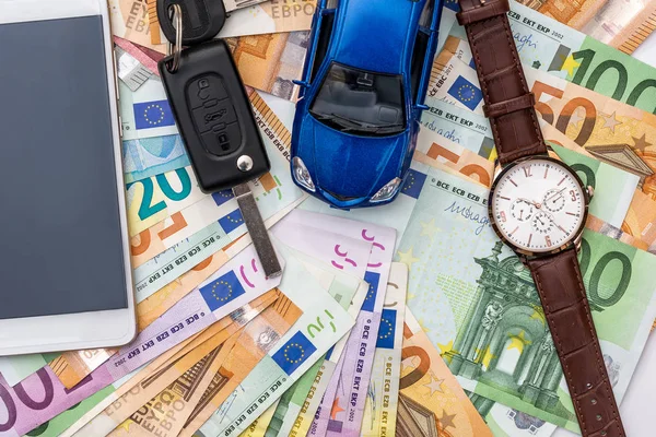 Rent car conception, car with keys and watch on money