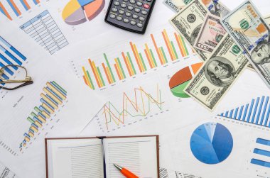 office scene:financial graph and chart, calculator, notepad, pen and money