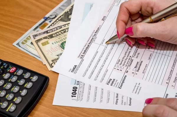 Business woman working with tax form documents with money